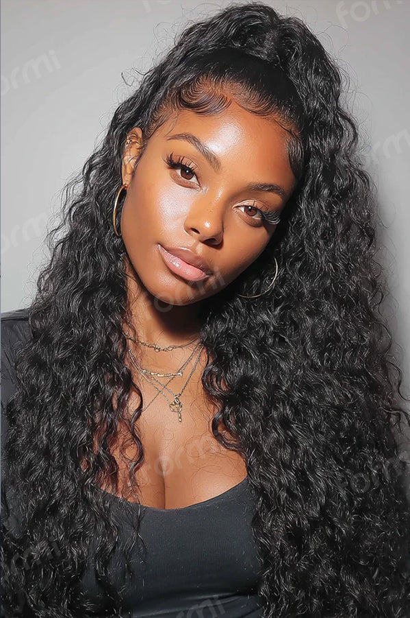 Black woman wearing natural black water wave crochet hair in a half-up style