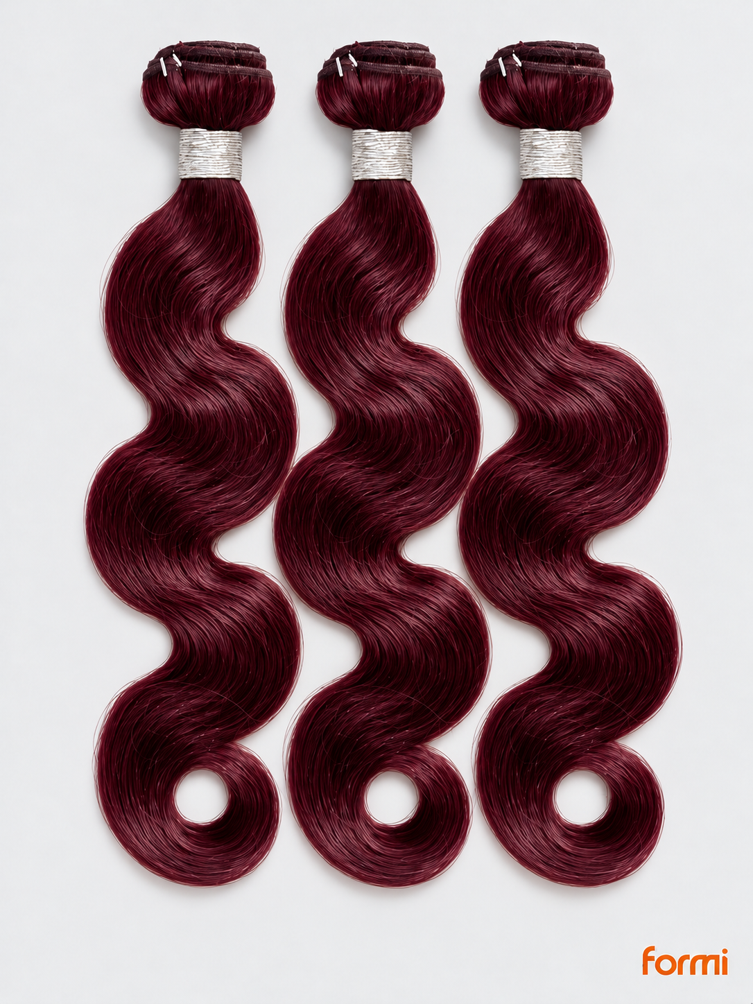 Three 99J burgundy body wave human hair bundles with silver wraps on a pale gray background.