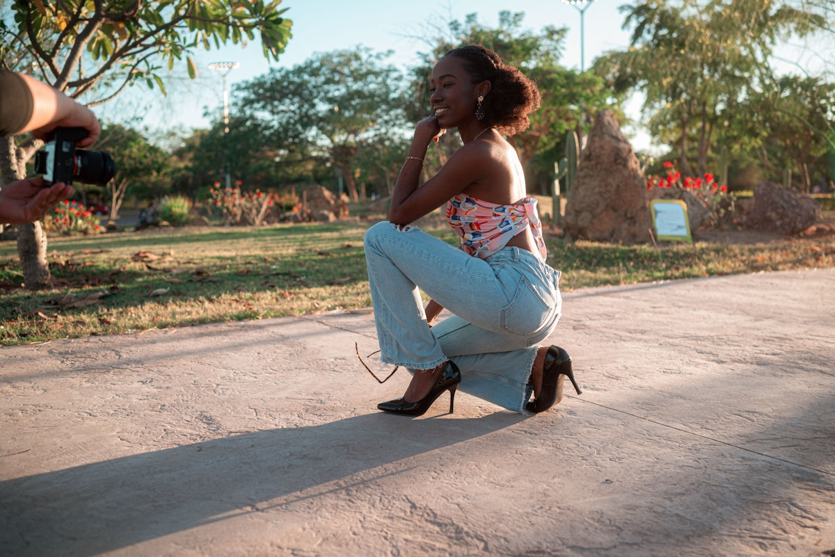Woman posing for a camera in a park.