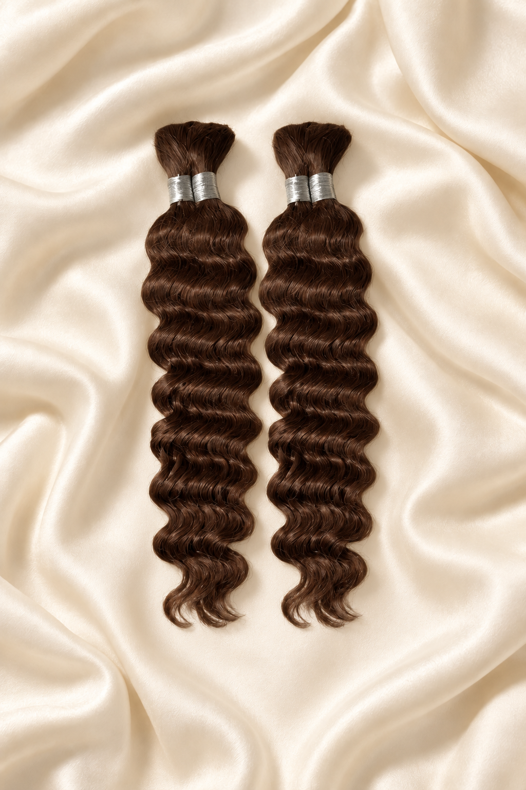 Two #30 auburn deep wave human hair bundles for boho braids displayed on ivory silk