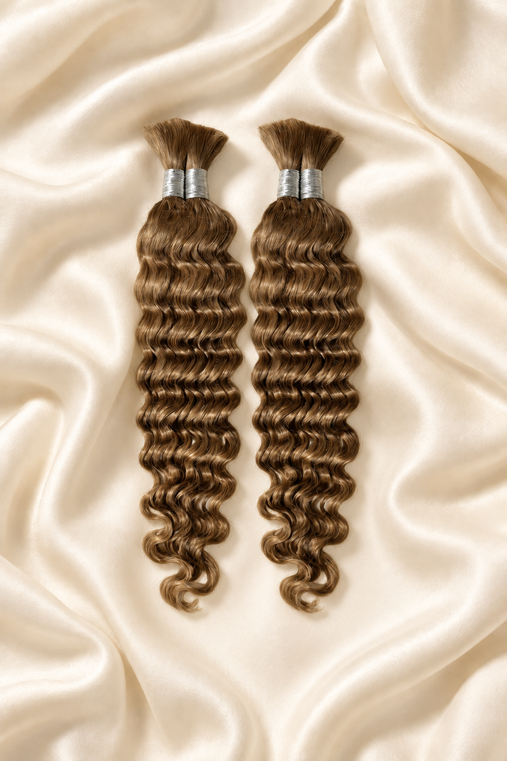 Two #27 honey blonde deep wave human hair bundles for boho braids displayed on ivory silk