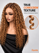 Deep side part and defined spiral curls on #27 human hair wig