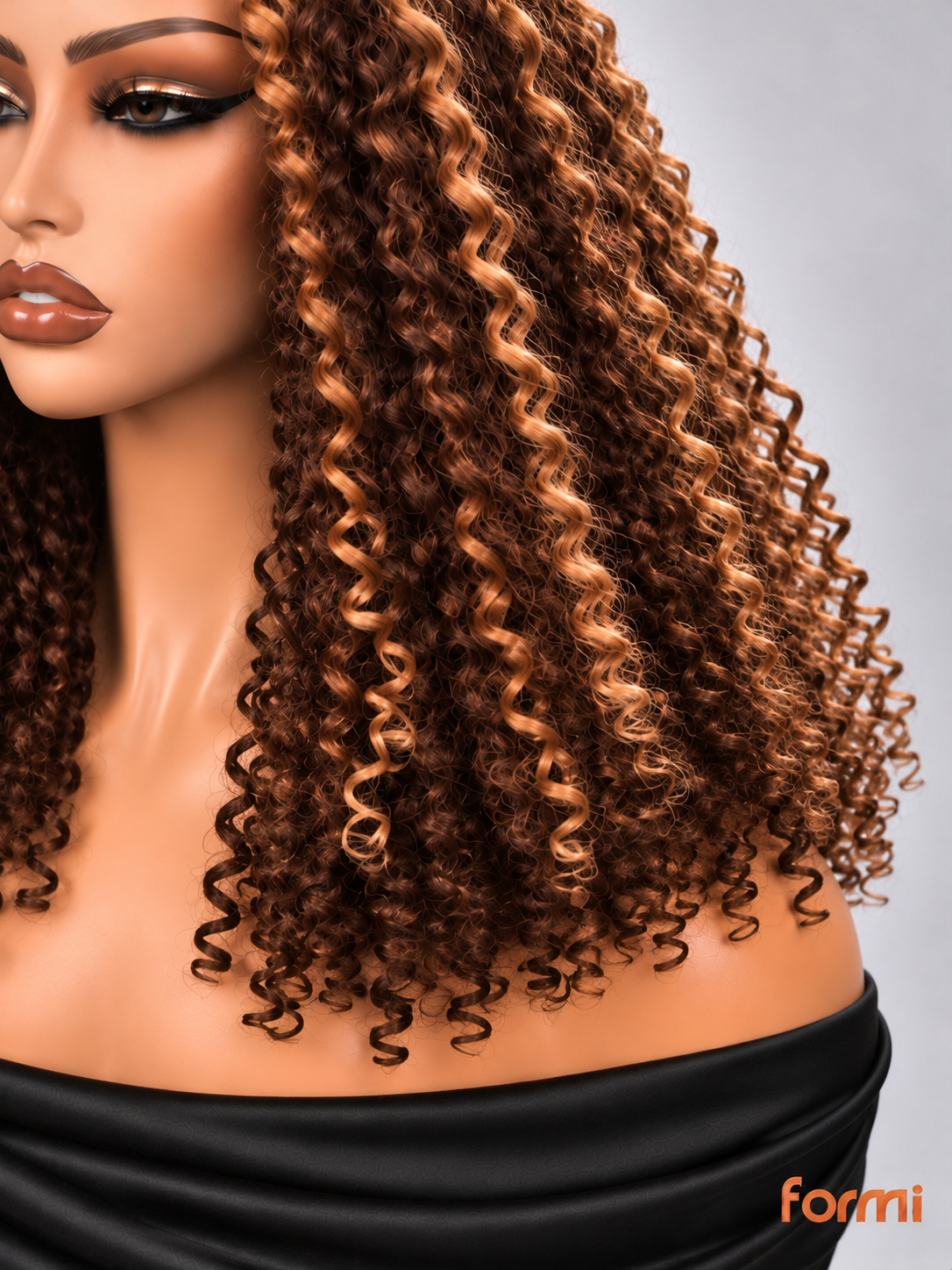 Close-up of #27 honey blonde highlights and defined spiral curl texture