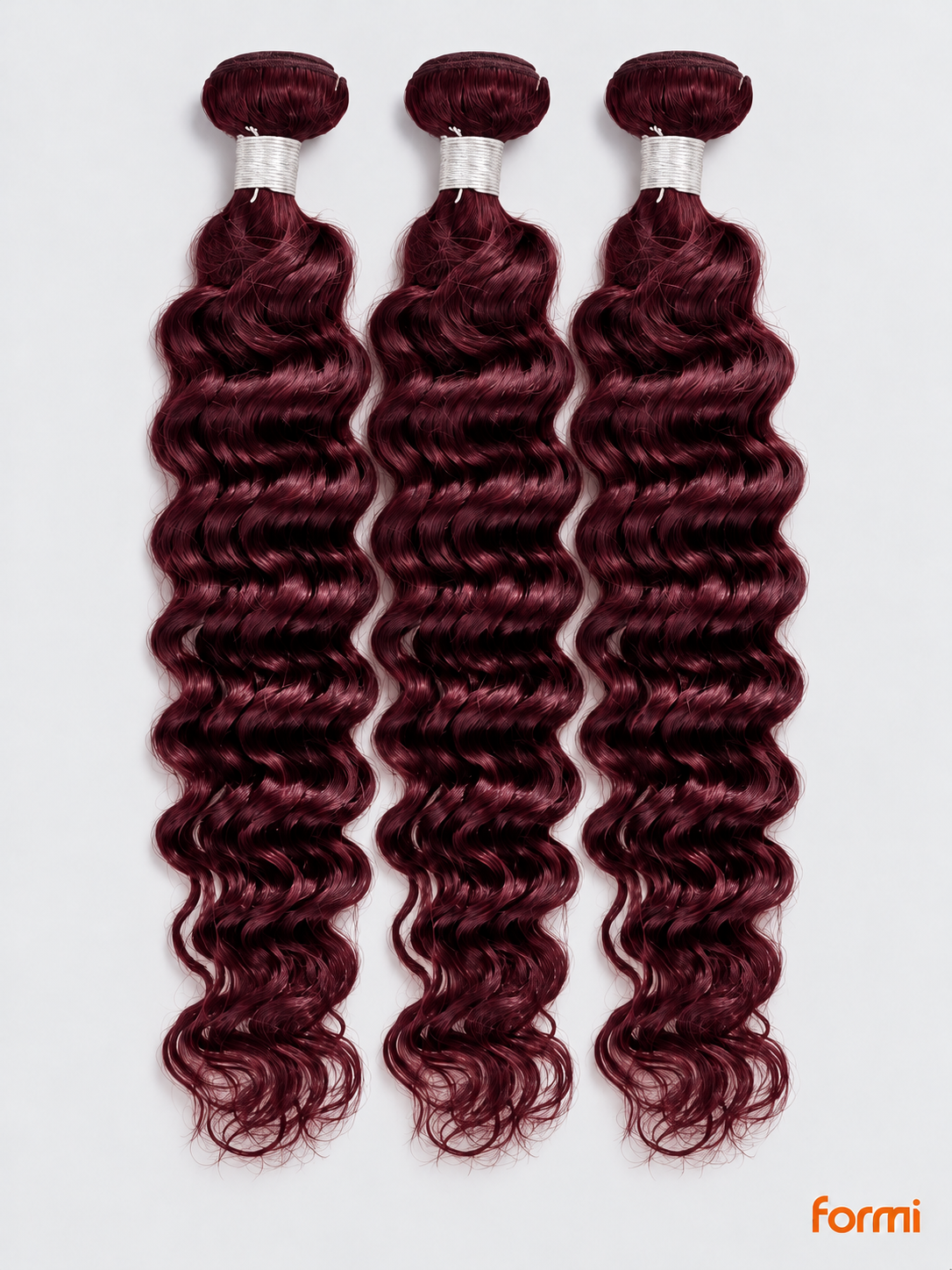 Three 99J burgundy deep wave human hair bundles with silver wraps on a pale gray background.