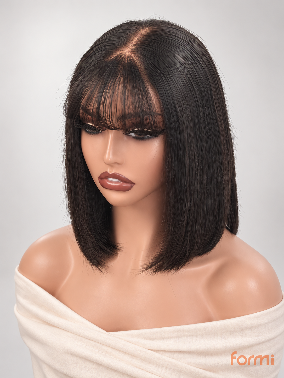 Natural black straight bob human hair wig with wispy bangs on a mannequin