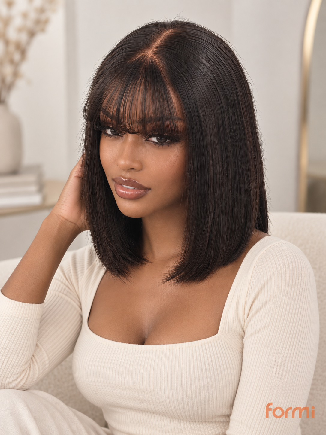 Studio view of natural black bob wig with soft wispy fringe